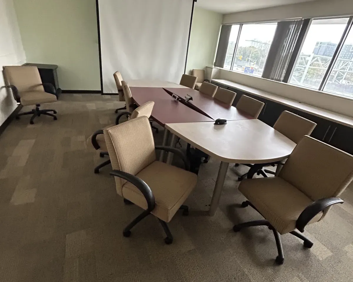 Furnished conference room with table and chairs before a commercial office decommissioning in New York City