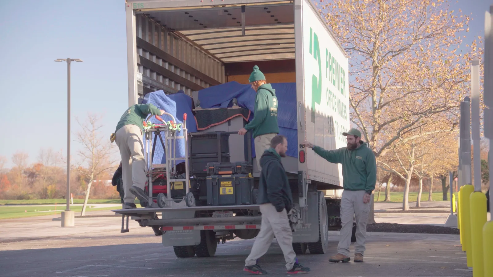 Uniformed Premier Office Movers crew loading a truck together at a Columbus, OH commercial move site