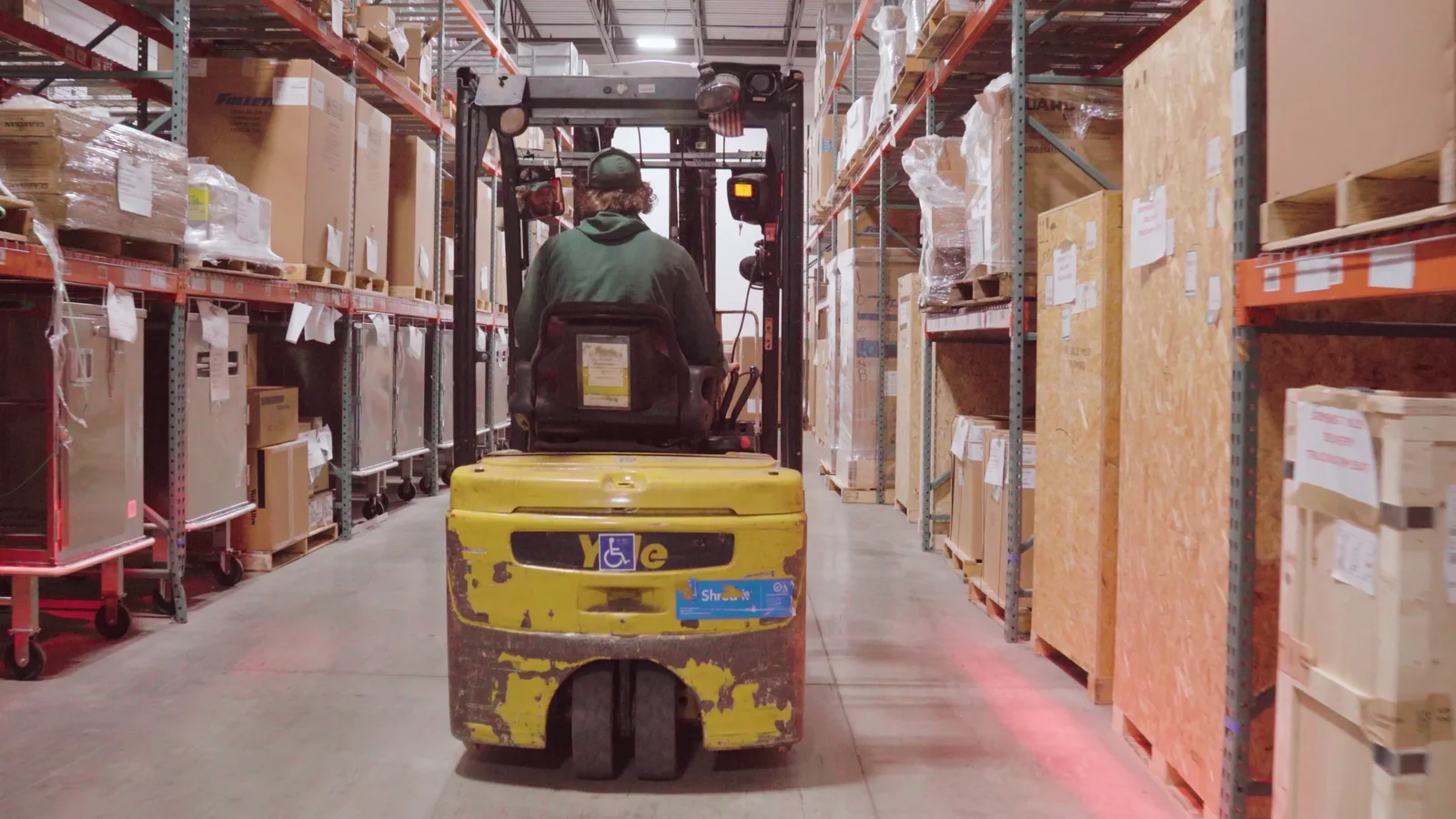A Premier Office Movers crew member operating a forklift in the Columbus, OH commercial storage warehouse
